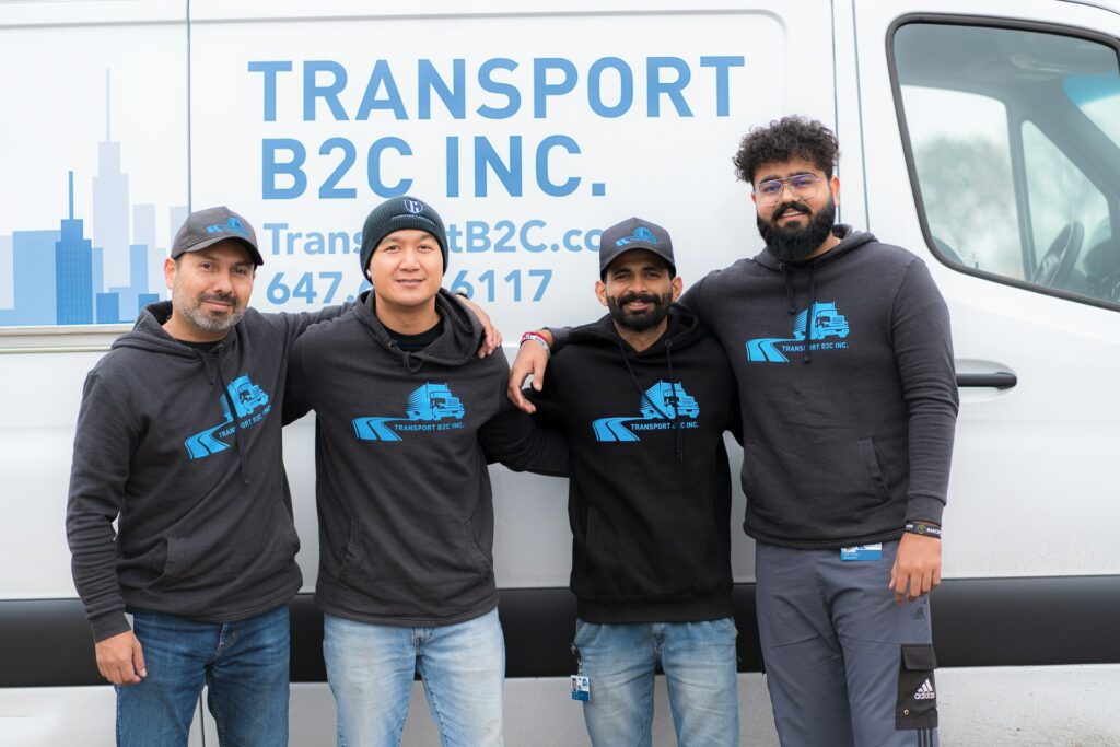 Transport B2C delivery team stands in front of a van